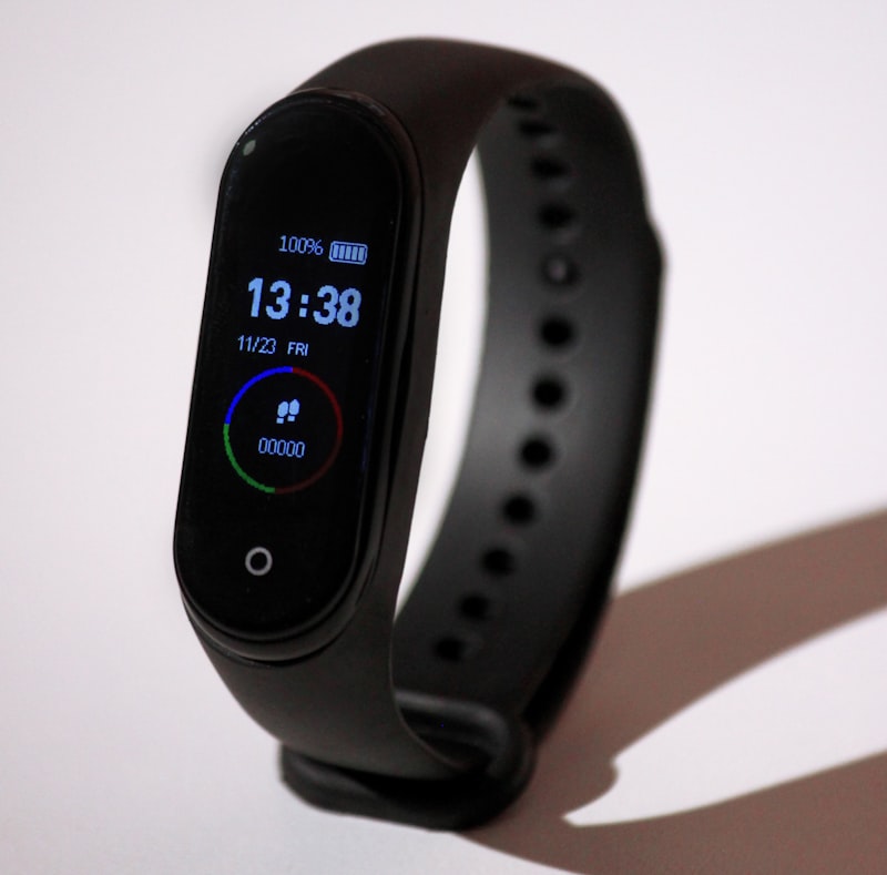 NOVU FitBand Pro fitness tracker on a wrist showing heart rate data