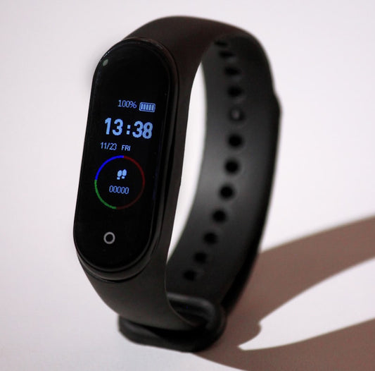 NOVU FitBand Pro fitness tracker on a wrist showing heart rate data
